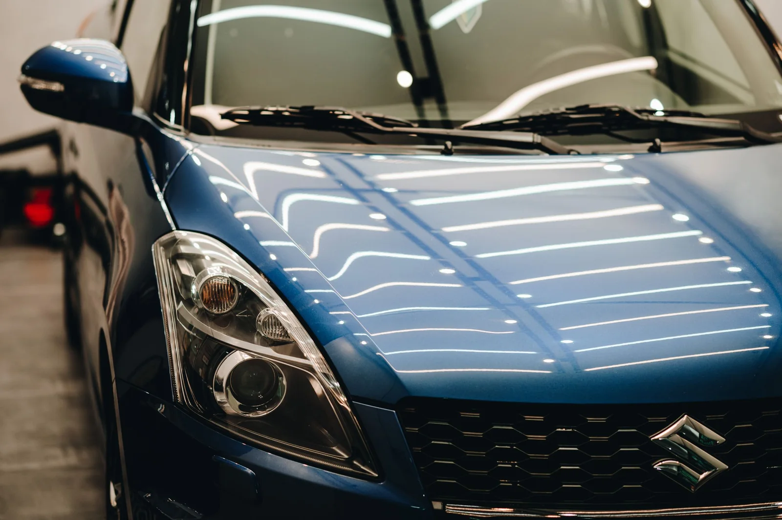 Lights reflected in deep, glossy blue paint