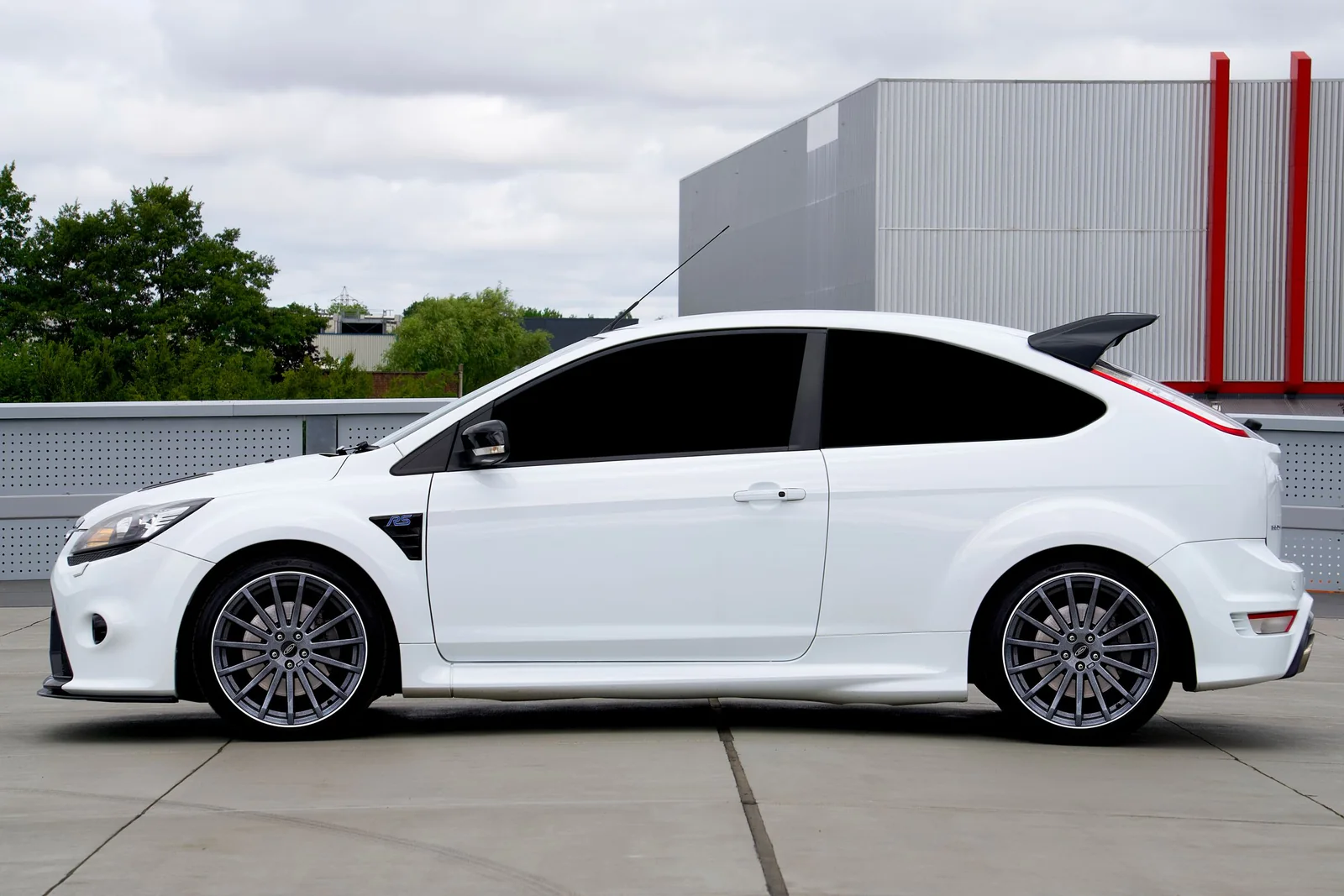 A white hatchback with every window in one even dark shade