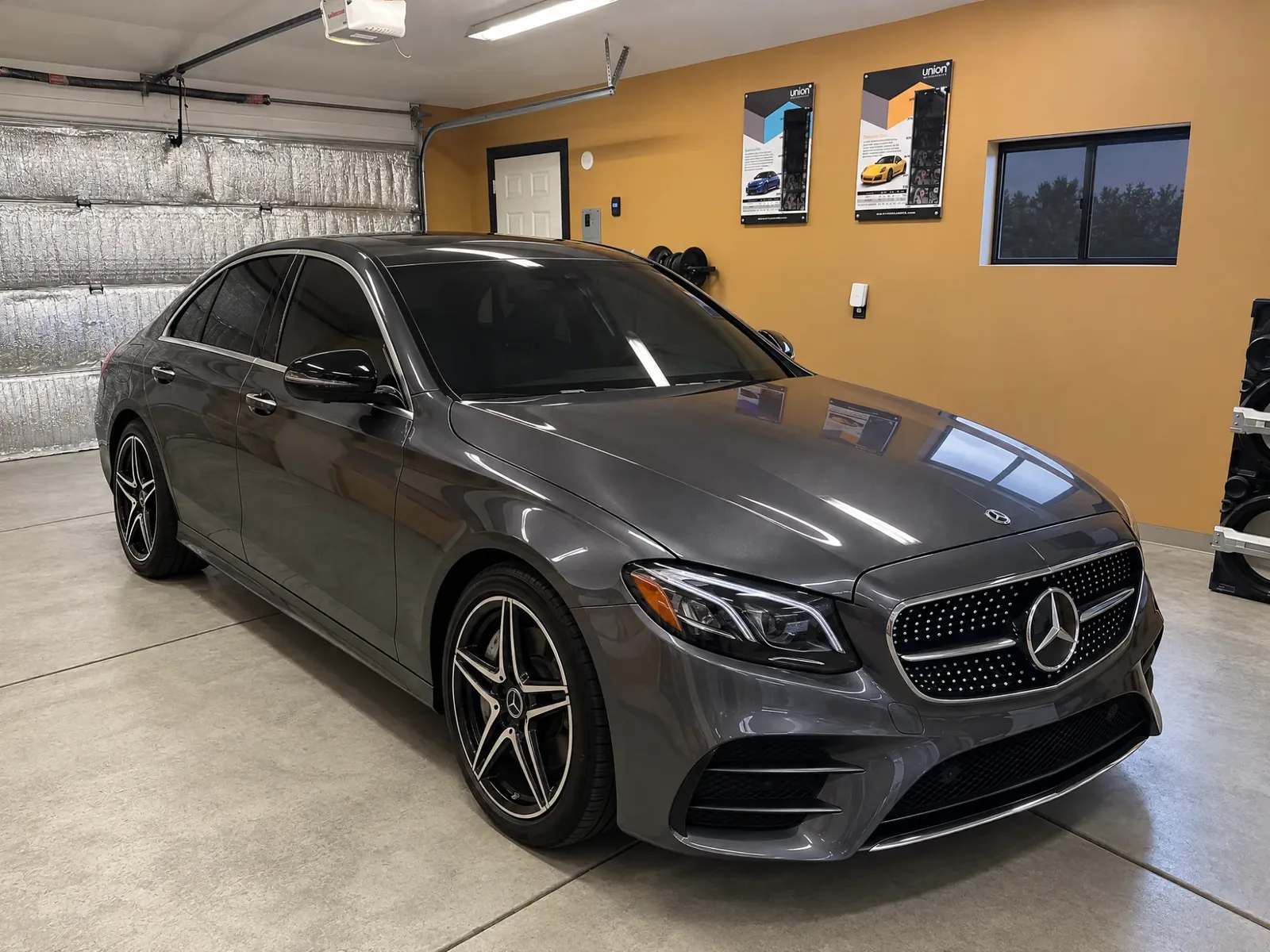 A dark gray Mercedes with tinted windows in the Asap Window Tint bay