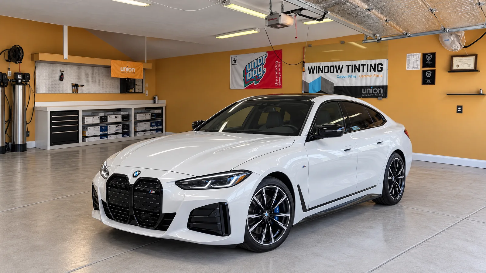 A white BMW i4 M50 with freshly tinted windows in the Asap Window Tint shop in West Valley City